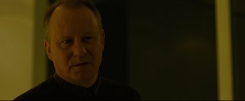 Movie still from “The Girl with the Dragon Tattoo” (2011), directed by David Fincher – A person wearing a black shirt; Close Up shot, Over the shoulder angle