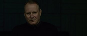 Movie still from “The Girl with the Dragon Tattoo” (2011), directed by David Fincher – A person wearing a black shirt; Close Up shot, Low angle