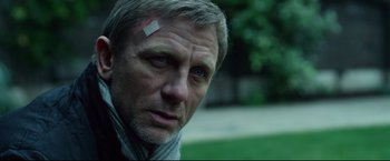 Movie still from “The Girl with the Dragon Tattoo” (2011), directed by David Fincher – A person with a bandage on his head; Close Up shot, Over the shoulder angle