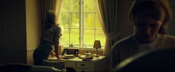Movie still from “The Girl with the Dragon Tattoo” (2011), directed by David Fincher – A woman standing in front of a window looking outside; Medium shot, Over the shoulder angle