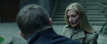 Movie still from “The Girl with the Dragon Tattoo” (2011), directed by David Fincher – A woman sitting next to a man on a street; Close Up shot, Over the shoulder angle