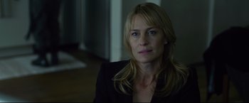 Movie still from “The Girl with the Dragon Tattoo” (2011), directed by David Fincher – A person sitting in a room; Close Up shot, Over the shoulder angle