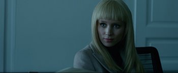 Movie still from “The Girl with the Dragon Tattoo” (2011), directed by David Fincher – A woman with blonde hair and blue eyes looking at the camera; Close Up shot, Over the shoulder angle