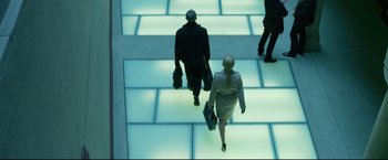 Movie still from “The Girl with the Dragon Tattoo” (2011), directed by David Fincher – A man and a woman are walking down the stairs; Wide shot, Low angle