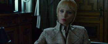 Movie still from “The Girl with the Dragon Tattoo” (2011), directed by David Fincher – A woman with blonde hair wearing a white jacket; Close Up shot, Low angle