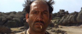 Movie still from “The Good, the Bad and the Ugly” (1966), directed by Sergio Leone – A person with a cigarette in his mouth; Close Up shot, Low angle