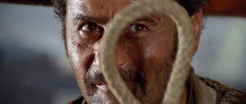 Movie still from “The Good, the Bad and the Ugly” (1966), directed by Sergio Leone – A man's face with a rope around his neck; Extreme Close Up shot, Low angle