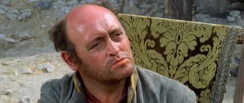 Movie still from “The Good, the Bad and the Ugly” (1966), directed by Sergio Leone – A man sitting in a chair with his eyes closed; Close Up shot, Low angle