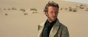 Movie still from “The Good, the Bad and the Ugly” (1966), directed by Sergio Leone – A person wearing a suit and tie; Close Up shot, Low angle