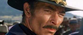 Movie still from “The Good, the Bad and the Ugly” (1966), directed by Sergio Leone – A person wearing a hat; Close Up shot, Over the shoulder angle