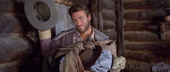 Movie still from “The Good, the Bad and the Ugly” (1966), directed by Sergio Leone – A man with a beard and a hat in a room; Close Up shot, Low angle