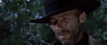 Movie still from “The Good, the Bad and the Ugly” (1966), directed by Sergio Leone – A man with a beard wearing a black hat; Close Up shot, Low angle