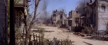 Movie still from “The Good, the Bad and the Ugly” (1966), directed by Sergio Leone – An old abandoned town with smoke billowing out of the roof; Extreme Wide shot, High angle