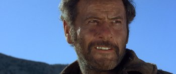 Movie still from “The Good, the Bad and the Ugly” (1966), directed by Sergio Leone – An old man with a beard and a mustache; Close Up shot, Low angle