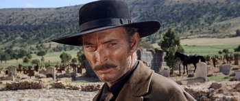 Movie still from “The Good, the Bad and the Ugly” (1966), directed by Sergio Leone – A person wearing a suit and a hat; Close Up shot, Low angle