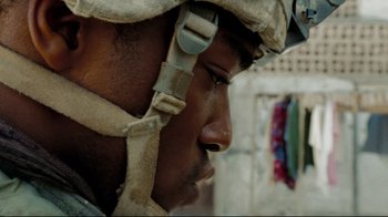 Movie still from “The Hurt Locker” (2008), directed by Kathryn Bigelow – A person wearing a helmet; Close Up shot, Over the shoulder angle