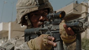 Movie still from “The Hurt Locker” (2008), directed by Kathryn Bigelow – A soldier is aiming a rifle at a target; Close Up shot, Low angle