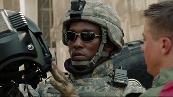 Movie still from “The Hurt Locker” (2008), directed by Kathryn Bigelow – A man in a military uniform is holding a gun; Close Up shot, Low angle