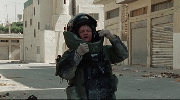 Movie still from “The Hurt Locker” (2008), directed by Kathryn Bigelow – A person in a military uniform is crying; Medium shot, High angle