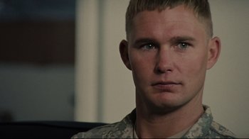 Movie still from “The Hurt Locker” (2008), directed by Kathryn Bigelow – A person wearing a military uniform; Close Up shot, Over the shoulder angle