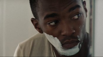 Movie still from “The Hurt Locker” (2008), directed by Kathryn Bigelow – A person with shaving cream on his face; Close Up shot, Over the shoulder angle
