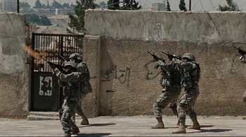 Movie still from “The Hurt Locker” (2008), directed by Kathryn Bigelow – A group of men in fatigues are holding guns; Wide shot, High angle