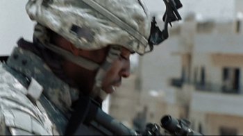 Movie still from “The Hurt Locker” (2008), directed by Kathryn Bigelow – A soldier with a rifle in his hand; Close Up shot, Low angle