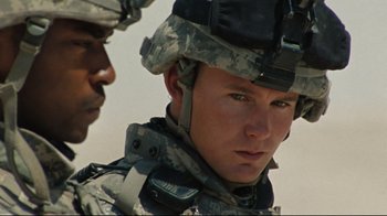Movie still from “The Hurt Locker” (2008), directed by Kathryn Bigelow – Two men in military uniforms looking at the camera; Close Up shot, Over the shoulder angle