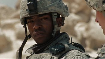 Movie still from “The Hurt Locker” (2008), directed by Kathryn Bigelow – A person wearing a helmet; Close Up shot, Over the shoulder angle