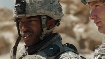 Movie still from “The Hurt Locker” (2008), directed by Kathryn Bigelow – A person wearing a helmet; Close Up shot, Over the shoulder angle