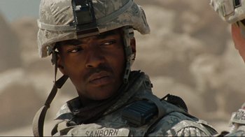Movie still from “The Hurt Locker” (2008), directed by Kathryn Bigelow – A person wearing a helmet; Close Up shot, Over the shoulder angle