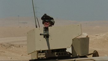 Movie still from “The Hurt Locker” (2008), directed by Kathryn Bigelow – A soldier is sitting on top of an armored vehicle; Medium shot, Low angle
