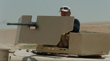 Movie still from “The Hurt Locker” (2008), directed by Kathryn Bigelow – A man sitting on top of an armored vehicle; Medium shot, High angle