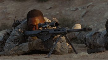 Movie still from “The Hurt Locker” (2008), directed by Kathryn Bigelow – A man in uniform is aiming with a rifle; Medium shot, High angle