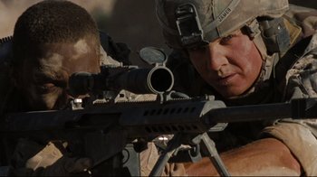 Movie still from “The Hurt Locker” (2008), directed by Kathryn Bigelow – A soldier is aiming a rifle at a target; Medium shot, Low angle