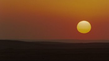 Movie still from “The Hurt Locker” (2008), directed by Kathryn Bigelow – The sun is setting over a large expanse of land; Extreme Wide shot, Low angle