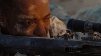 Movie still from “The Hurt Locker” (2008), directed by Kathryn Bigelow – A man with a gun looking at the ground; Extreme Close Up shot, High angle