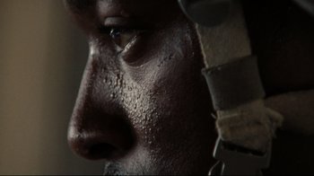 Movie still from “The Hurt Locker” (2008), directed by Kathryn Bigelow – View of a man's face with water droplets on it; Extreme Close Up shot, Low angle