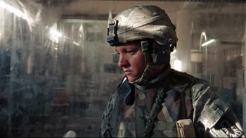 Movie still from “The Hurt Locker” (2008), directed by Kathryn Bigelow – A man wearing a helmet is standing in a room; Close Up shot, Low angle
