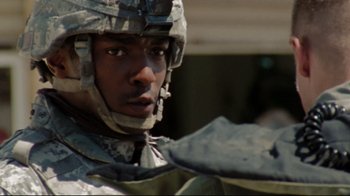 Movie still from “The Hurt Locker” (2008), directed by Kathryn Bigelow – A person wearing a helmet; Close Up shot, Over the shoulder angle