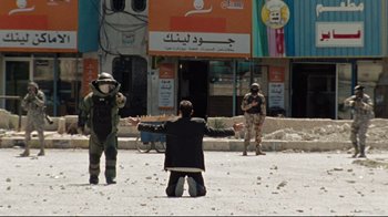 Movie still from “The Hurt Locker” (2008), directed by Kathryn Bigelow – A man standing in the middle of a street; Wide shot, Over the shoulder angle