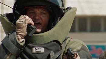 Movie still from “The Hurt Locker” (2008), directed by Kathryn Bigelow – A man in a helmet is holding a gun; Close Up shot, Low angle