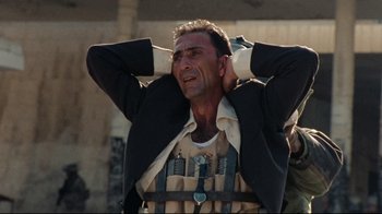 Movie still from “The Hurt Locker” (2008), directed by Kathryn Bigelow – A man with his hands behind his head and his eyes closed; Medium shot, Low angle