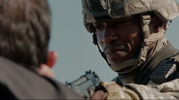 Movie still from “The Hurt Locker” (2008), directed by Kathryn Bigelow – A person with a gun; Close Up shot, Over the shoulder angle