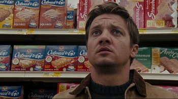 Movie still from “The Hurt Locker” (2008), directed by Kathryn Bigelow – A person in front of a shelf of cereal boxes; Close Up shot, Low angle