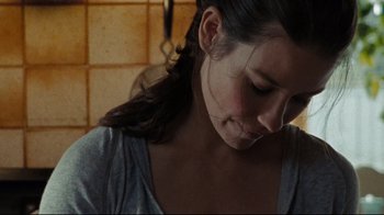 Movie still from “The Hurt Locker” (2008), directed by Kathryn Bigelow – A woman's face in a room; Close Up shot, High angle