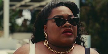 Movie still from “The Idol” (2023), directed by Sam Levinson – A person wearing sunglasses and a necklace; Close Up shot, Over the shoulder angle