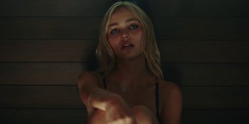 Movie still from “The Idol” (2023), directed by Sam Levinson – A beautiful young woman with long blonde wavy hair; Close Up shot, Low angle