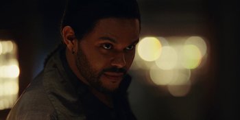 Movie still from “The Idol” (2023), directed by Sam Levinson – A person wearing a jacket; Close Up shot, Over the shoulder angle