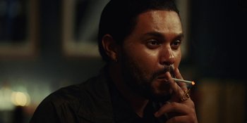 Movie still from “The Idol” (2023), directed by Sam Levinson – A person smoking a cigarette; Close Up shot, Over the shoulder angle